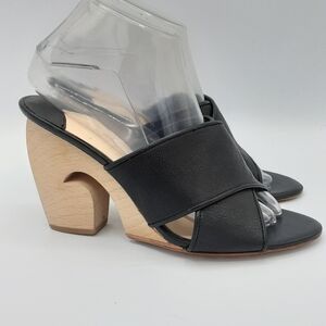 Isa Tapia Black Crisscross Strap Stacked Wooden Heel Mule.